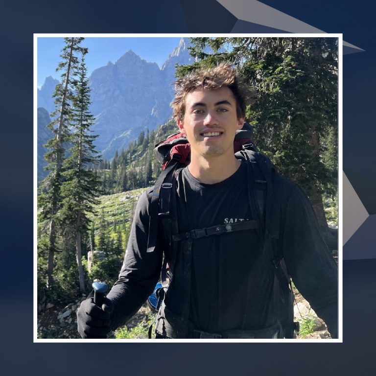 Theodore Walrond hiking with a backpack in the mountains